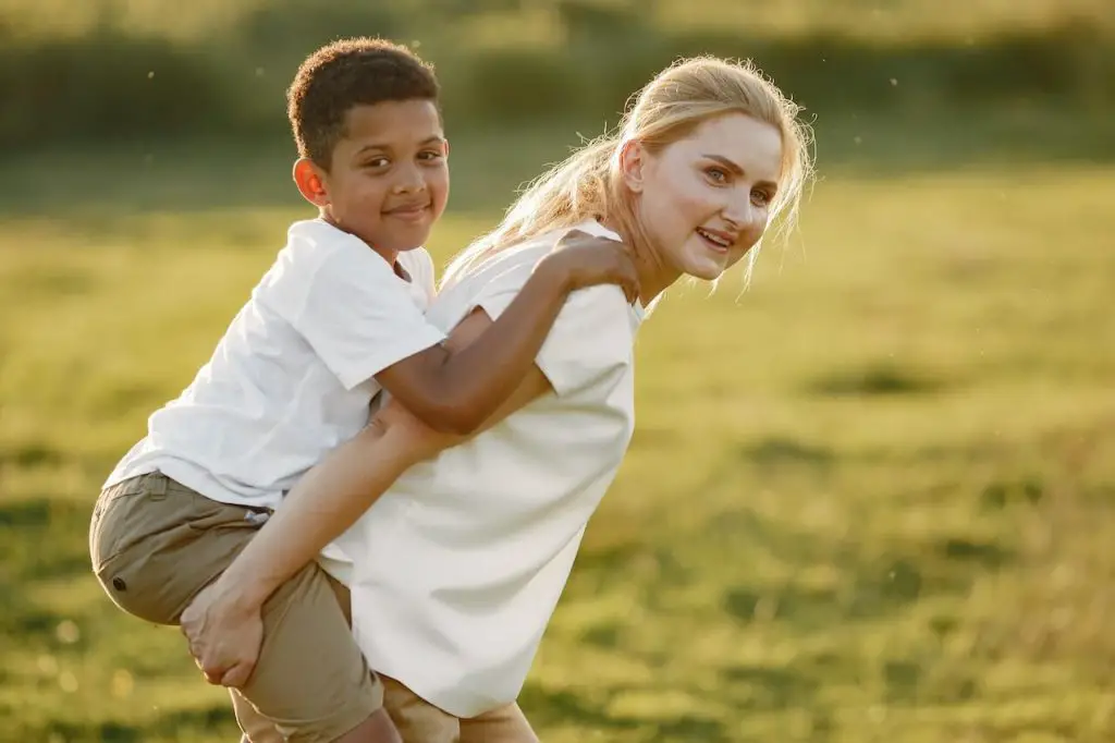 Mum Giving Her Son a Piggyback Ride