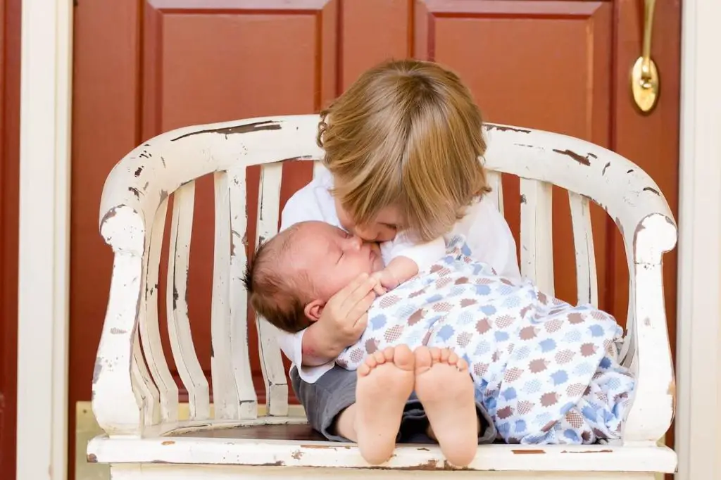 Capture Hugging Newborn Sibling